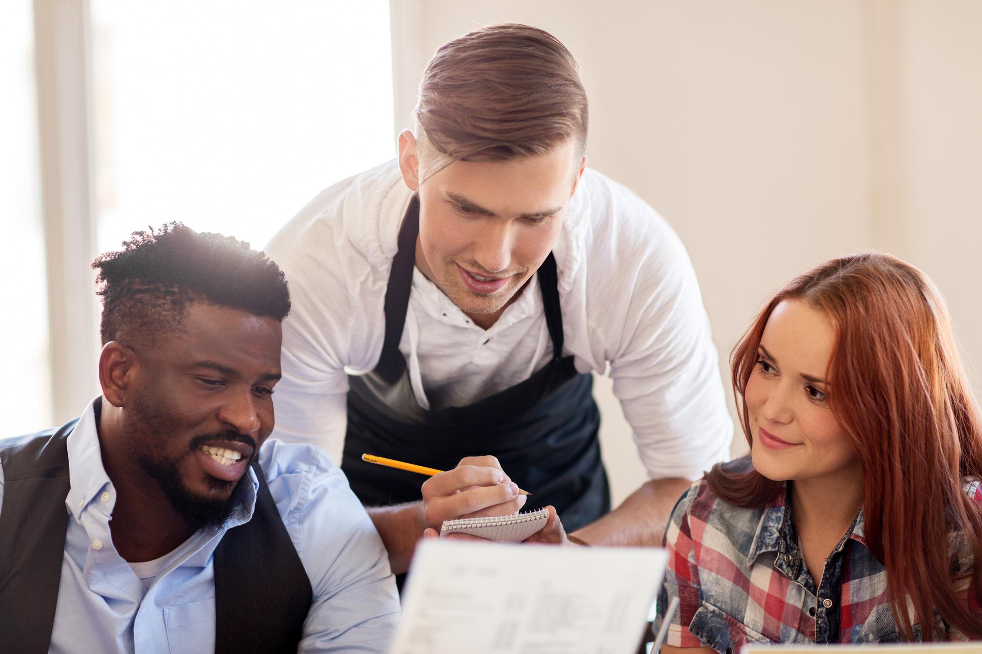 Team discussing menu with printed notes